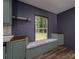 A cozy breakfast nook in kitchen features built-in seating beneath a window and green cabinets at 4920 Morrison Houser Trl # 2, Lincolnton, NC 28092