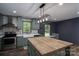 Charming kitchen featuring stylish green cabinets, a farmhouse sink, and a butcher block island with modern light fixtures at 4920 Morrison Houser Trl # 2, Lincolnton, NC 28092