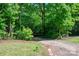 Beautiful lot featuring mature trees and a gravel driveway leading into a peaceful wooded area at 4920 Morrison Houser Trl # 2, Lincolnton, NC 28092