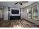 Spacious living room showcasing wood-look floors, a ceiling fan and a brick accent wall at 4920 Morrison Houser Trl # 2, Lincolnton, NC 28092