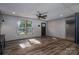 A spacious living room with wood-look flooring, ceiling fan, and natural light at 4920 Morrison Houser Trl # 2, Lincolnton, NC 28092