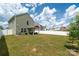 Green home exterior showcasing a spacious, fenced backyard with a covered patio at 507 Newfound Hollow Dr, Charlotte, NC 28214