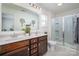 Bright bathroom features a double sink vanity, walk-in shower with glass enclosure, and modern finishes at 507 Newfound Hollow Dr, Charlotte, NC 28214