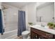 Well-lit bathroom features a shower-tub combo, vanity with storage, and a coordinated color scheme at 507 Newfound Hollow Dr, Charlotte, NC 28214