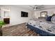 Inviting bedroom with a flat-screen TV, wood floors, ceiling fan, and an en-suite bathroom at 507 Newfound Hollow Dr, Charlotte, NC 28214