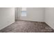 A cozy bedroom with neutral walls and plush carpeting, offering a blank canvas for personalization at 507 Newfound Hollow Dr, Charlotte, NC 28214
