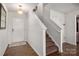 Bright entryway featuring wood floors, staircase, and a white front door at 507 Newfound Hollow Dr, Charlotte, NC 28214