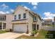 Two-story home boasts manicured lawn, attached garage, and a welcoming entrance at 507 Newfound Hollow Dr, Charlotte, NC 28214