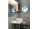 Functional bathroom featuring classic fixtures and unique octagon-shaped window at 523 Franklin Ave, Charlotte, NC 28206