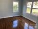 Bedroom featuring hardwood floors and two windows providing natural light at 523 Franklin Ave, Charlotte, NC 28206