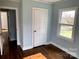 Bedroom featuring hardwood floors, one window, and an attached closet at 523 Franklin Ave, Charlotte, NC 28206