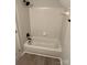 A bathroom with a white tiled tub and wooden floors at 5637 Hedgecrest Pl, Charlotte, NC 28269