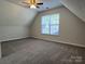 A carpeted bedroom with gray walls, a window, and a ceiling fan at 5637 Hedgecrest Pl, Charlotte, NC 28269