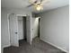 A bedroom with carpet, a ceiling fan, and an open closet at 5637 Hedgecrest Pl, Charlotte, NC 28269
