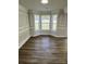Formal dining room featuring detailed wall paneling, hardwood floors, and a bay window at 5637 Hedgecrest Pl, Charlotte, NC 28269