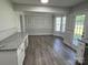 Dining room with wainscotting, natural light, and open access to the updated kitchen at 5637 Hedgecrest Pl, Charlotte, NC 28269