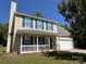 Classic two-story home with blue shutters, a covered front porch, and a well-manicured lawn at 5637 Hedgecrest Pl, Charlotte, NC 28269