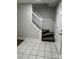 Foyer with tile entry, a staircase with white railing, and neutral paint throughout at 5637 Hedgecrest Pl, Charlotte, NC 28269