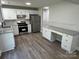 Bright kitchen featuring white cabinets, granite countertops, stainless steel appliances, and modern backsplash at 5637 Hedgecrest Pl, Charlotte, NC 28269