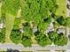 An aerial view highlighting the property's location and surrounding neighborhood with lush trees and a road nearby at 6012 Tuckaseegee Rd, Charlotte, NC 28208