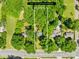 Aerial view of a property with a large lot surrounded by lush greenery and mature trees at 6012 Tuckaseegee Rd, Charlotte, NC 28208