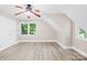 Bedroom featuring hardwood floors, a ceiling fan, and natural light from the windows at 6012 Tuckaseegee Rd, Charlotte, NC 28208