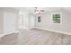 Spacious bedroom with hardwood floors, a ceiling fan, and multiple windows offering natural light at 6012 Tuckaseegee Rd, Charlotte, NC 28208