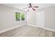 Cozy bedroom featuring new floors, neutral walls, ceiling fan, and a bright window at 6012 Tuckaseegee Rd, Charlotte, NC 28208