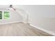 Bedroom featuring hardwood floors, a ceiling fan, and natural light from the windows at 6012 Tuckaseegee Rd, Charlotte, NC 28208