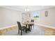 Cozy dining area with modern table, chairs and a view to the outdoors at 6012 Tuckaseegee Rd, Charlotte, NC 28208