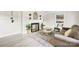 Bright living room showcasing a fireplace, wood flooring, and neutral color palette at 6012 Tuckaseegee Rd, Charlotte, NC 28208
