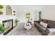 Cozy living room features a fireplace, plush rug, neutral decor, and bright windows at 6012 Tuckaseegee Rd, Charlotte, NC 28208