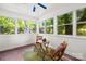 Inviting sun room filled with natural light, featuring cozy seating and views to the outdoors at 6012 Tuckaseegee Rd, Charlotte, NC 28208
