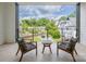 Cozy balcony area with two chairs and a table overlooking a picturesque neighborhood view at 614 Queens Rd, Charlotte, NC 28207