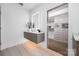 Modern bathroom boasts a floating vanity, stylish light-up mirrors, and a closet at 614 Queens Rd, Charlotte, NC 28207