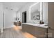 Sleek bathroom features floating vanity, light-up mirrors, and stylish tile flooring at 614 Queens Rd, Charlotte, NC 28207
