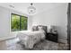 Cozy bedroom featuring a large window, neutral color palette, and stylish decor at 614 Queens Rd, Charlotte, NC 28207