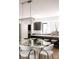 Open-concept kitchen and dining area featuring modern lighting and a breakfast bar at 614 Queens Rd, Charlotte, NC 28207