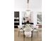 Bright dining room featuring glass table, modern chandelier, and stylish black built-in cabinets at 614 Queens Rd, Charlotte, NC 28207