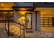 A stylish modern townhouse entrance featuring a well-lit walkway, black-framed glass door, and dark accents at 614 Queens Rd, Charlotte, NC 28207