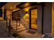 A modern townhouse entrance is well-lit with a black-framed glass door and dark accents at 614 Queens Rd, Charlotte, NC 28207