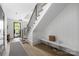 Bright entryway with hardwood floors, modern staircase, and convenient bench seating at 614 Queens Rd, Charlotte, NC 28207