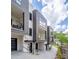 Modern exterior featuring gray siding, brick accents, balconies, and stylish black framed windows at 614 Queens Rd, Charlotte, NC 28207
