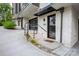 Modern townhouse featuring brick accents, stylish glass garage door, and stairs to front door at 614 Queens Rd, Charlotte, NC 28207