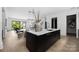 Bright kitchen features an island with white countertops and black cabinets in an open concept floor plan at 614 Queens Rd, Charlotte, NC 28207