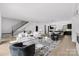 Spacious living room featuring a fireplace, hardwood floors, and modern decor at 614 Queens Rd, Charlotte, NC 28207