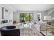 Bright living room with a glass coffee table, fireplace, and a sliding door to the outside at 614 Queens Rd, Charlotte, NC 28207