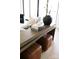 Close up of stylish living room table with decorative books and leather ottomans underneath at 614 Queens Rd, Charlotte, NC 28207