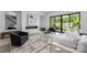 Bright open concept living room with a modern fireplace and a sliding glass door to the patio at 614 Queens Rd, Charlotte, NC 28207