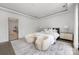 Bright main bedroom features a tray ceiling, a rug, and a sitting area at 614 Queens Rd, Charlotte, NC 28207